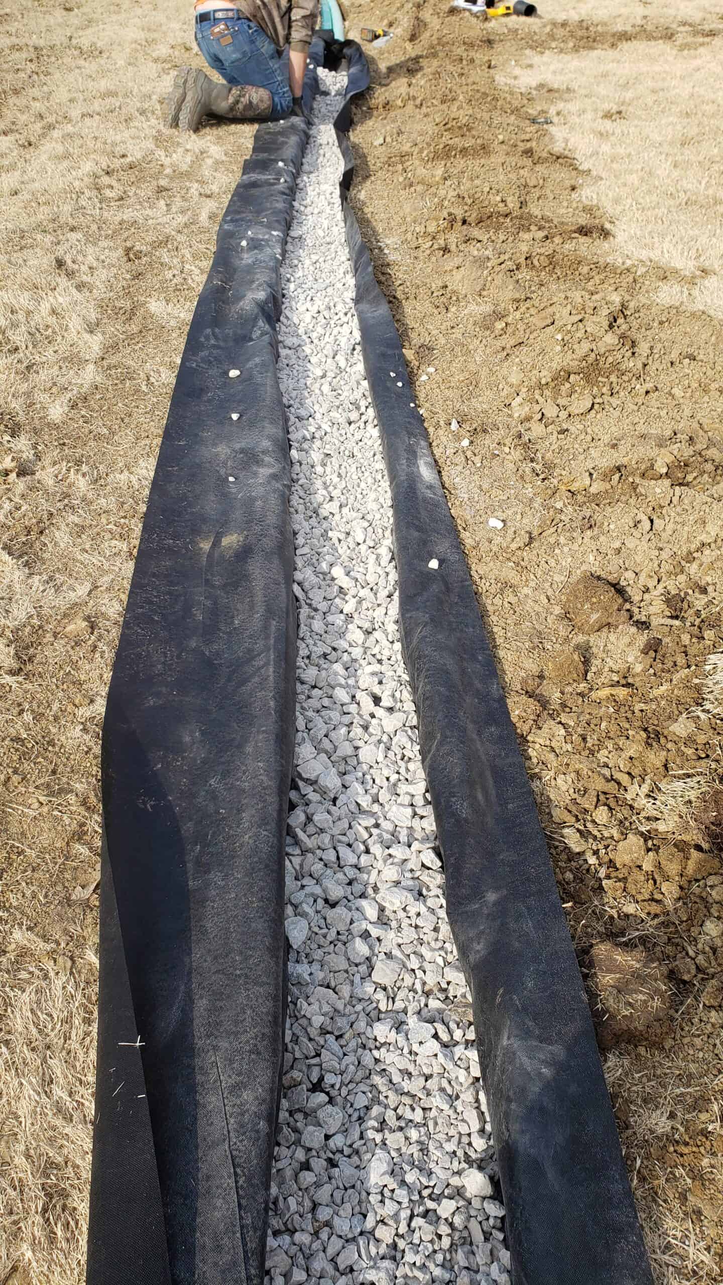 Fair workers installing a drain